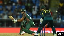 angladesh's captain Najmul Hossain Shanto plays a shot past Australia's Matthew Wade during the ICC men's Twenty20 World Cup 2024 Super Eight cricket match between Australia and Bangladesh at Sir Vivian Richards Stadium in North Sound, Antigua and Barbud