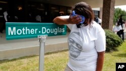 A mourner is overcome with grief after viewing the body of George Floyd during his memorial service, June 6, 2020, in Raeford, N.C. 