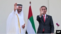 FILE - Abu Dhabi's Crown Prince Sheikh Mohammed bin Zayed Al Nahyan, left, and Indonesian President Joko Widodo wave at photographers during their meeting at the presidential palace in Bogor, Indonesia, July 24, 2019.