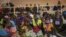 FILE - People displaced from Palma by armed insurgents are seen gathered to receive humanitarian aid, in Pemba, Cabo Delgado province, Mozambique, April 2, 2021.