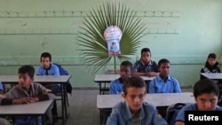 FILE - A picture of Palestinian schoolboy Muhand Abu Malhous, who was killed in Gaza, is seen on his chair at his classroom in a school in the central Gaza Strip, Nov. 16, 2019. 