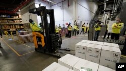 Boxes containing the Pfizer-BioNTech COVID-19 vaccine are prepared to be shipped at the Pfizer Global Supply Kalamazoo manufacturing plant in Portage, Michigan, Dec. 13, 2020. 