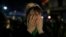 A pro-choice activist holds her face after lawmakers voted against a bill that would have legalized elective abortion in the first 14 weeks of pregnancy, outside Congress in Buenos Aires, Argentina, early Aug. 9, 2018. Argentina allows the procedure only in cases of rape or risks to a woman's health. 