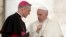 FILE - Pope Francis shares a word with Prefect of the Papal Household Georg Ganswein (L) during his weekly general audience, in St. Peter's Square, at the Vatican, May 2, 2018.