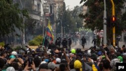 Riot police and demonstrators face off during a national protest against tax reform in Bogotá, Colombia, April 28, 2021. (Pu Ying Huang/VOA)