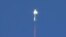 The New Shepard booster rocket, owned by Jeff Bezos' space company, Blue Origin, is shown at the moment of separation during the escape module testing in Culberson County, Texas, Oct. 5, 2016. 