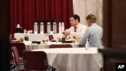 In this March 20, 2020, photo Sen. Rand Paul, right, who later tested positive for the coronavirus, has lunch with Sen. Marco Rubio.