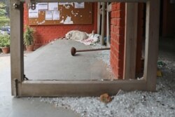 A glass scattered entrance to the Sabarmati hostel is seen vandalized in Sunday's assault by masked assailants at the Jawaharlal Nehru University in New Delhi, India, Jan. 6, 2020.