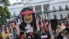 FILE - Indigenous rights activists take part in a rally in support of imprisoned Native American activist Leonard Peltier, at Lafayette Square across from the White House, in Washington, Sept. 12, 2023. 