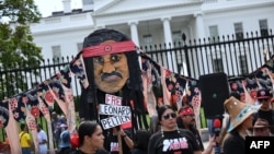 FILE - Indigenous rights activists take part in a rally in support of imprisoned Native American activist Leonard Peltier, at Lafayette Square across from the White House, in Washington, Sept. 12, 2023. 