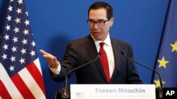 FILE - U.S. Treasury Secretary Steven Mnuchin speaks during a news conference with France's Economy Minister Bruno Le Maire after a meeting in Paris, Feb. 27, 2019.
