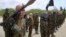 (FILE) Al-Shabab fighters display weapons as they conduct military exercises in northern Mogadishu, Somalia, on Oct. 21, 2010. 