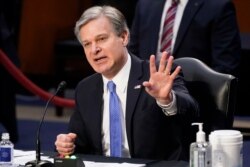 FILE - FBI Director Christopher Wray testifies before the Senate Judiciary Committee on Capitol Hill in Washington, March 2, 2021. Wray is condemning the Jan. 6 riot at the Capitol as 'domestic terrorism.'