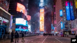 FILE - Confetti flies after the Times Square New Year's Eve ball drops in a nearly empty Times Square, in New York City, early Jan. 1, 2021, as the area normally packed with revelers remained closed off due to the ongoing coronavirus pandemic.