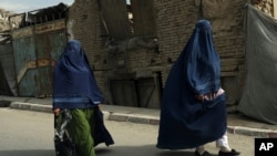 Afghan women in burqas walk on a street in Kabul, Afghanistan, Aug. 22, 2021.