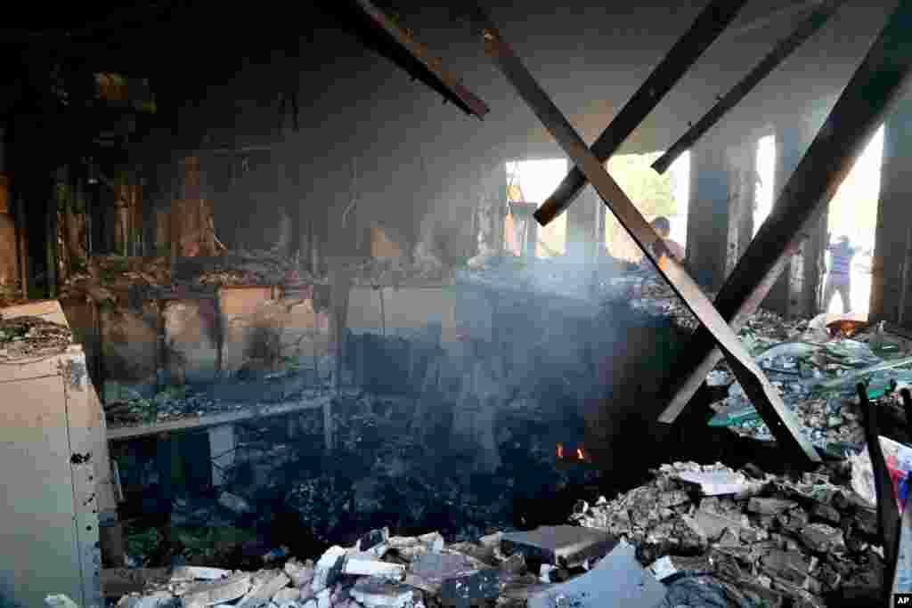 Smoke rises from the reception room of the U.S. embassy that was burned by Pro-Iranian militiamen and their supporters, in Baghdad, Iraq, Jan. 1, 2020.