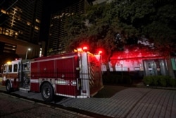 A firetruck is positioned outside the Chinese Consulate, July 22, 2020, in Houston.