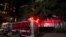 A firetruck is positioned outside the Chinese Consulate, July 22, 2020, in Houston. Witnesses said that people were burning paper in what appeared to be trash cans, according to police.
