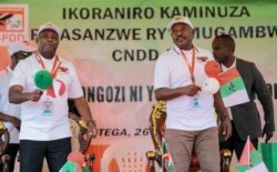 FILE - Burundi Army Gen. Evariste Ndayishimiye, left, is accompanied by current president Pierre Nkurunziza after being chosen as the party's presidential candidate at a conference for the ruling CNDD-FDD party in Gitega, Burundi, Jan. 26, 2020.