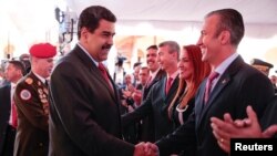 Venezuela's President Nicolas Maduro, left, shakes hands with Venezuela's new vice president, Tarek El Aissami, during a meeting with ministers in Caracas, Jan. 4, 2017.