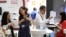 Vendors explain their products on the opening day of the Computex exhibition at the Taipei World Trade Center in Taipei, Taiwan, June 5, 2012.