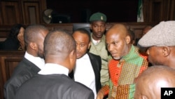 FILE - Biafran separatist leader Nnamdi Kanu, center right, speaks to his lawyers at the Federal High court in Abuja, Nigeria, Jan. 29, 2016. 