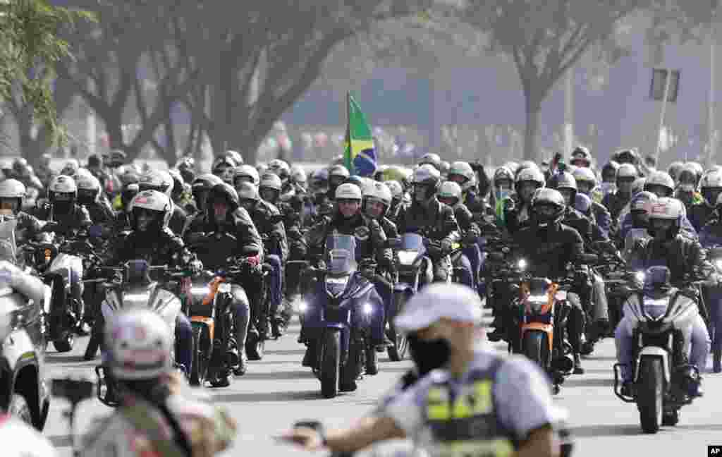 Brazil&#39;s President Jair Bolsonaro, center, takes part in a caravan of motorcycle enthusiasts in Sao Paulo, Brazil, June 12, 2021.