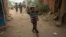 A Somali boy carries a tray of nuts and snacks on top of his head as he walks near a market place in the town of Jawhar in Middle Shabelle region, north of the Somali capital Mogadishu, December 11, 2012.