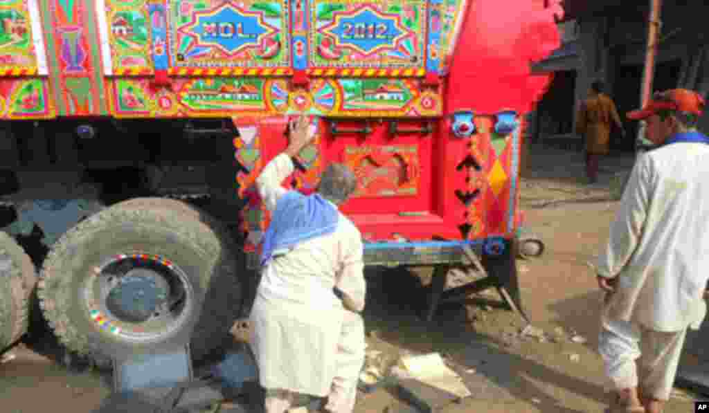 A boy tries to push a sumo wrestler during an exhibition titled "Sumo Tournament In Jakarta," at Istora stadium in Jakarta, Indonesia.