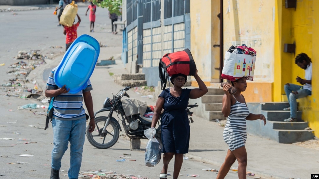 People flee their neighborhood after armed gangs terrorized the Delmas 24 and Solino areas, in Port-au-Prince, Haiti, Oct. 20, 2024. 