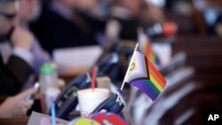 A small flag celebrating LGBTQ rights decorates a desk on the Democratic side of the Kansas House of Representatives during a debate, March 28, 2023, at the Statehouse in Topeka, Kansas.