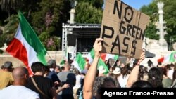 FILE - Protesters take part in a demonstration against the introduction of a mandatory "green pass" to limit the spread of COVID-19, at the Piazza del Popolo, in central Rome, Italy, Aug. 7, 2021. 