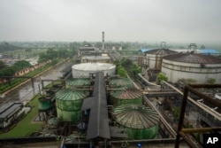 Fermenters and tanks containing molasses sit at Bajaj Hindustan Sugar factory that produces ethanol, a type of biofuel, in Meerut, India, on August 23, 2023. (AP Photo/Altaf Qadri)