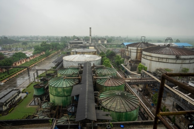 Fermenters and tanks containing molasses sit at Bajaj Hindustan Sugar factory that produces ethanol, a type of biofuel, in Meerut, India, on August 23, 2023. (AP Photo/Altaf Qadri)