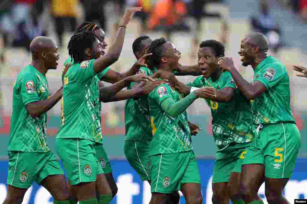 Zimbabwe&#39;s Kudakwashe Mahachi celebrates scoring their second goal with teammates in the match against Guinea; Cameroon, Jan. 18, 2022.