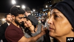 FILE - TOPSHOT - People react after lighting candles in memory of the 1,400 victims killed during the October 7 attack by Palestinian militants from the Gaza Strip at the Western Wall in Jerusalem on November 6, 2023 amid the ongoing battles between Israel and Hamas.