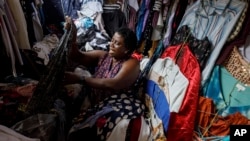 A secondhand retailer sorts out clothes at Kantamanto, one of the world's largest second-hand clothing markets, in Accra, Ghana, Oct. 26, 2024.