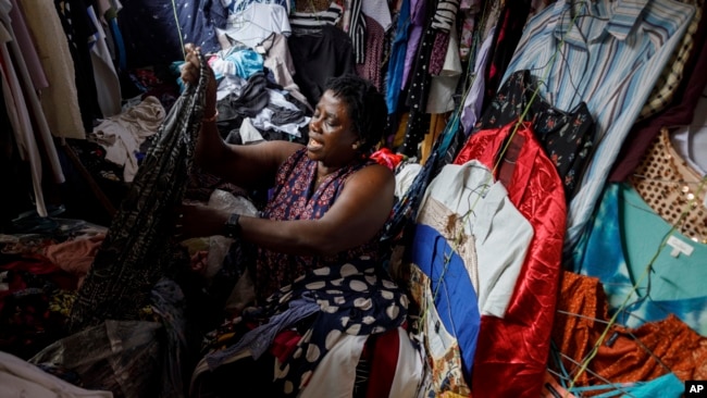 A secondhand retailer sorts out clothes at Kantamanto, one of the world's largest second-hand clothing markets, in Accra, Ghana, Oct. 26, 2024.