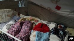 Premature babies who were left behind by their parents lay in a bed in hospital number 3 in Mariupol, Ukraine, March 15, 2022. 