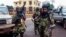 Fighters for the Seleka rebel alliance stand guard in front of the presidential palace in Bangui, Central African Republic, March 25, 2013.