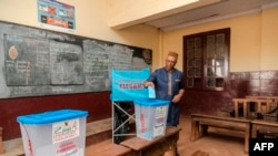 FILE - The Governor of the Central Region of Cameroon, Paul Naseri Bea, casts his ballot in the general and municipal elections in Yaounde on Feb. 9, 2020. 