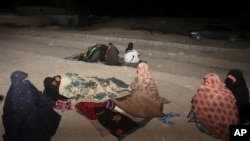 FILE - In this photo taken April 16, 2013, Iranians stay outside their homes at the Gosht district after an earthquake hit southeastern Iran. A 7.3 magnitude quake hit Iran Sunday on its border with Iraq.