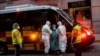 A patient, center, is transferred to a medicalized hotel during the COVID-19 outbreak in Madrid, Spain, March 24, 2020.