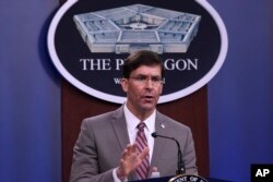 FILE - Defense Secretary Mark Esper speaks during a briefing at the Pentagon in Washington, March 2, 2020.