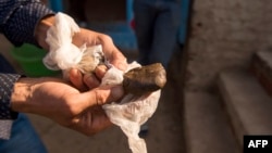 Un agriculteur expose un morceau de résine de cannabis (haschisch) près de la ville de Ketama dans la région nord du Rif au Maroc, le 13 septembre 2017.
