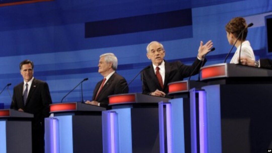 Republican presidential candidates from left, former Massachusetts Gov. Mitt Romney, former House Speaker Newt Gingrich, Rep. Ron Paul, R-Texas, and Rep. Michele Bachmann, R-Minn., participate in a Republican presidential debate in Sioux City, Iowa, Dec.
