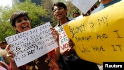 Demonstrators hold placards as they shout slogans during a protest outside police headquarters in New Delhi, April 20, 2013, after a five year-old girl was allegedly raped and tortured.