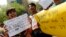 Demonstrators hold placards as they shout slogans during a protest outside police headquarters in New Delhi, April 20, 2013, after a five year-old girl was allegedly raped and tortured.