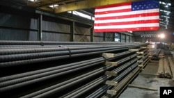FILE - Steel rods produced at the Gerdau Ameristeel mill await shipment in St. Paul, Minn., May 9, 2019.