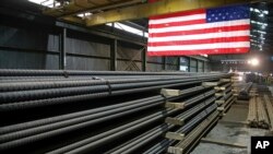 FILE - Steel rods produced at the Gerdau Ameristeel mill await shipment in St. Paul, Minn., May 9, 2019.
